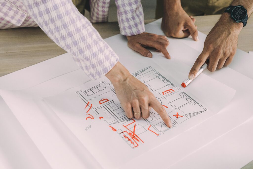 Design review or planning session, highlighting the collaborative effort in architectural or interior design projects. 